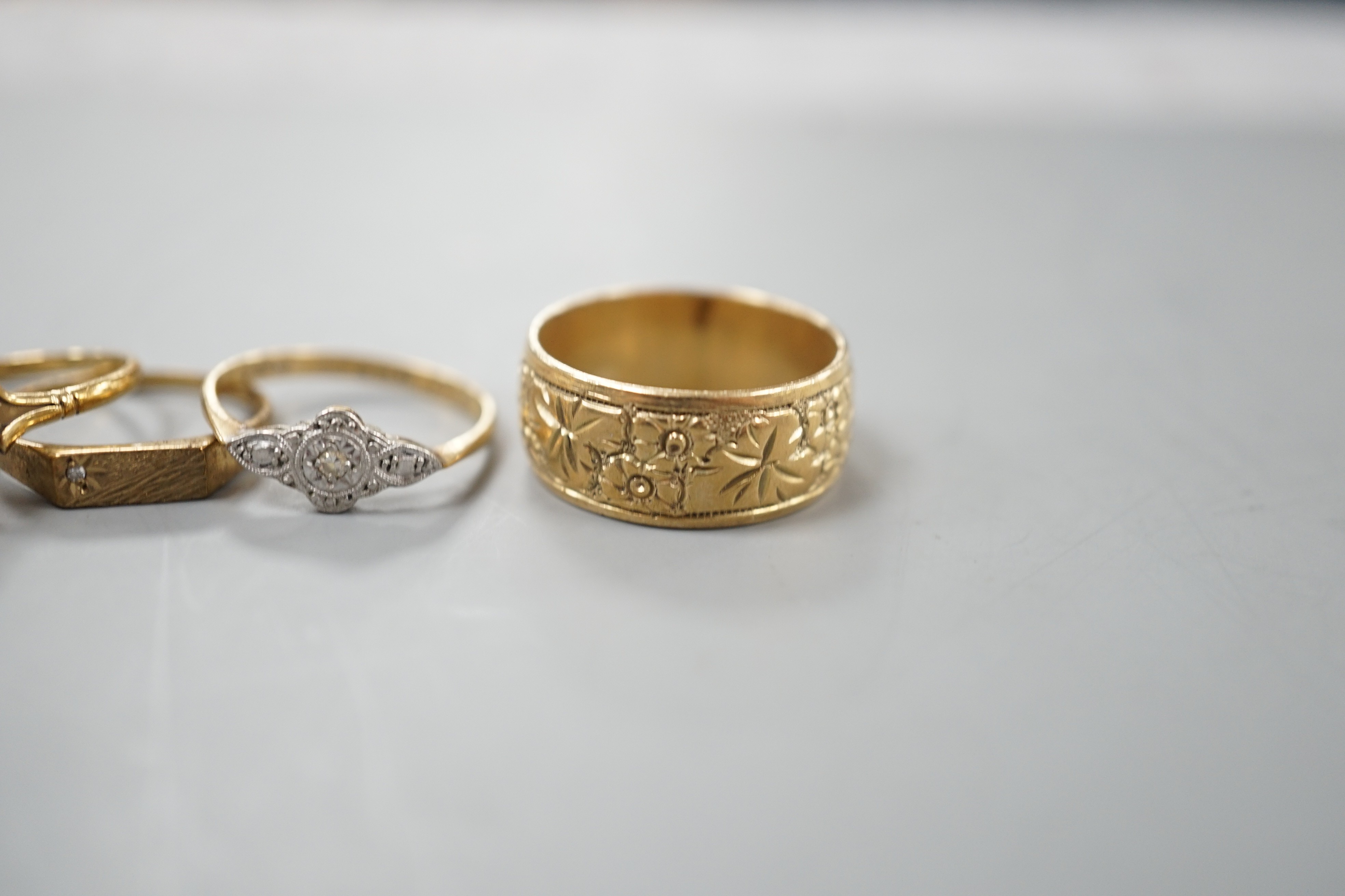 Four assorted 9ct rings, including band, white opal set, diamond chip set and millegrain diamond set, gross 11 grams.